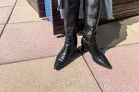 A person wears the Naturalizer Deesha Knee High Boots