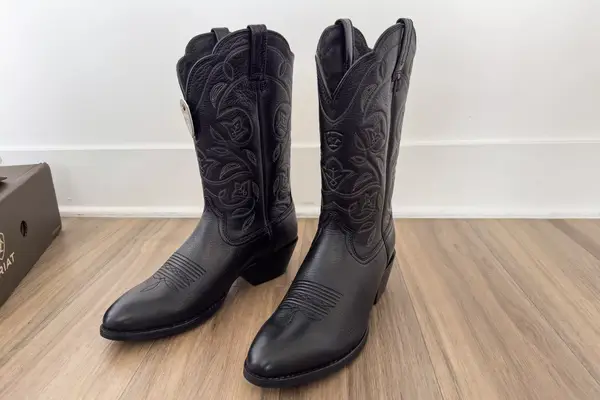 A pair of Ariat Heritage R Toe Western Boots on a wooden floor