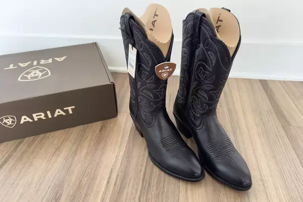 A pair of Ariat Heritage R Toe Western Boots with the tags on