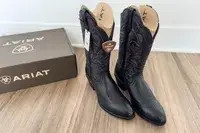 A pair of Ariat Heritage R Toe Western Boots with the tags on