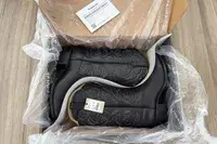 A pair of Ariat Heritage R Toe Western Boots in a box