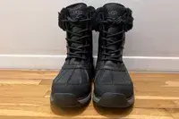 A pair of UGG Adirondack III Boots on a wooden floor