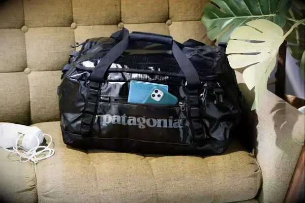 Patagonia Black Hole 40L Duffel Bag displayed on a sofa
