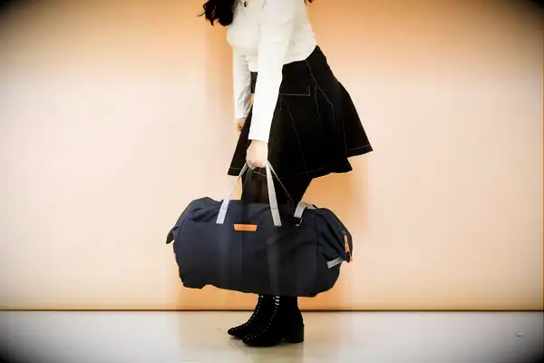 Person wearing the Patagonia Black Hole 40L Duffel Bag over one shoulder