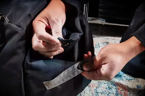 Hands measuring the Patagonia Black Hole 40L Duffel Bag