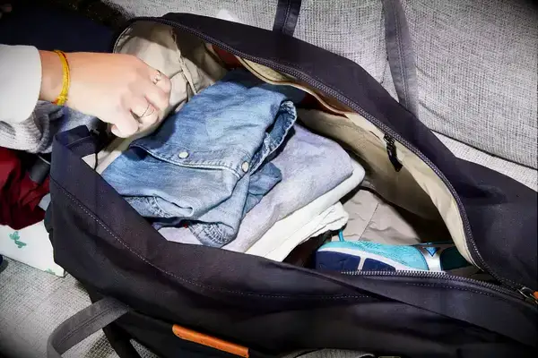 Patagonia Black Hole 40L Duffel Bag displayed on a sofa