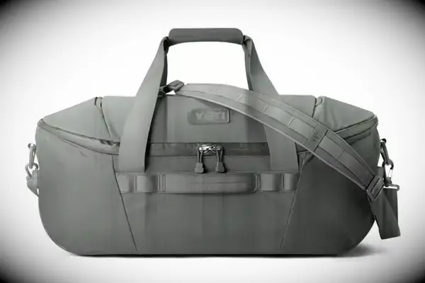 Hands unsnapping part of the Bellroy Classic Weekender 45L