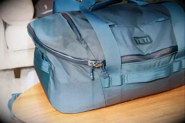 Hand packing clothes into the Bellroy Classic Weekender 45L