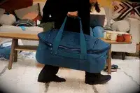 Person pushing the Bellroy Classic Weekender 45L off a counter