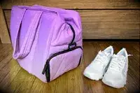 The Calpak Luka Large Duffel next to a pair of sneakers