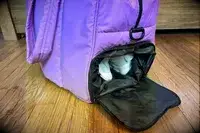 A close up of the shoe compartment of the Calpak Luka Large Duffel