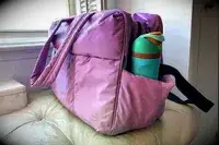 A water bottle in the side pocket of the Calpak Luka Large Duffel