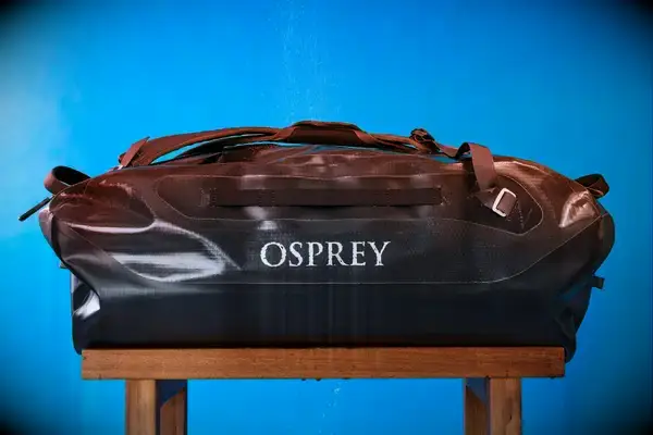 The Osprey Transporter Waterproof Duffel 70L is sprayed with water