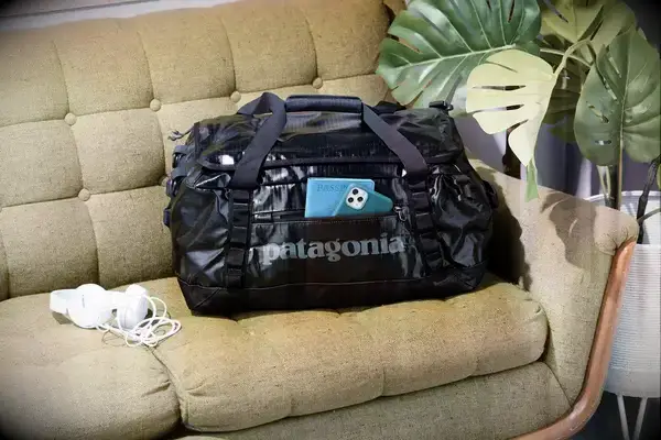 Patagonia Black Hole 40L Duffel Bag displayed on a sofa
