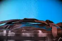 Water is sprayed on the Osprey Transporter Waterproof Duffel 70L