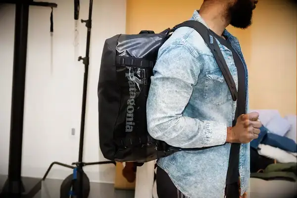 Person wearing the Patagonia Black Hole 40L Duffel Bag over one shoulder