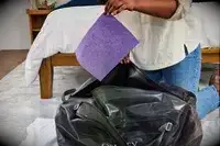 A piece of paper is removed from the Osprey Transporter Waterproof Duffel 70L