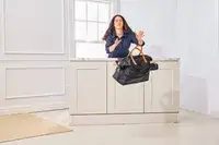 A person throws the Mark & Graham Terminal 1 Expandable Travel Tote off of a table