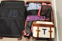 The Mark & Graham Terminal 1 Cosmetic Case inside luggage