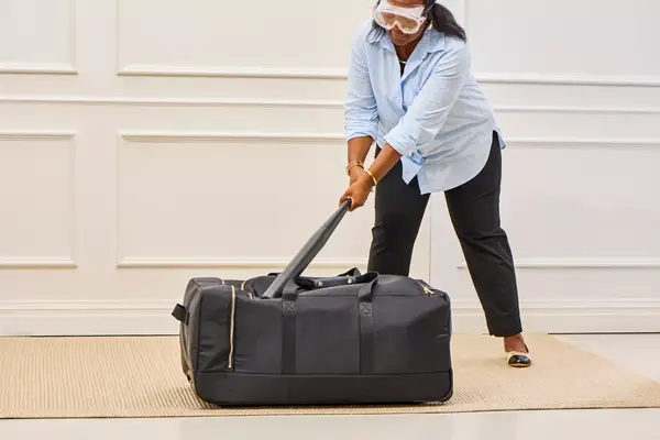 Man holding straps of the Mark & Graham Canvas and Leather Weekender