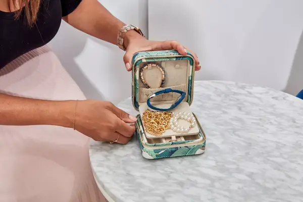 Hands holding an opened Mark & Graham Small Travel Jewelry Case