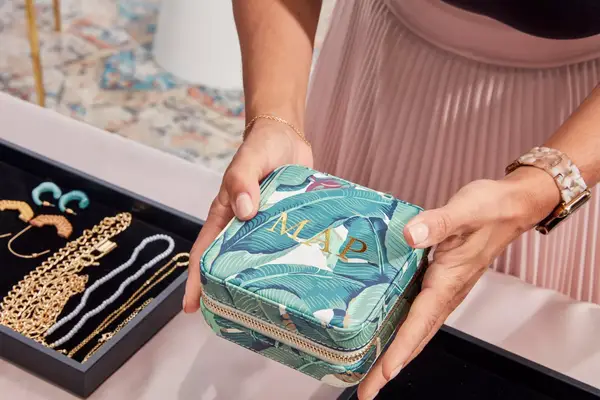 Hands holding a closed Mark & Graham Small Travel Jewelry Case