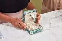 Hands holding an opened Mark & Graham Small Travel Jewelry Case