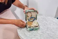 Hands holding an opened Mark & Graham Small Travel Jewelry Case