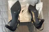 Closeup of the Calvin Klein Larin Pumps in a shoe box turned sole-side up