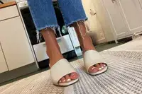 Closeup of a person wearing the Aerosoles Entree Shoe in a kitchen