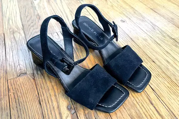 Donald Pilner Aaro Sandals sitting on a wood floor