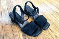 Donald Pilner Aaro Sandals sitting on a wood floor