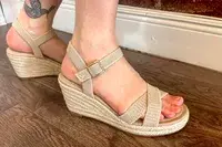 A person wearing the Vivaia Round Toe Wedge Sandals