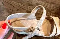 A close up of the Vivaia Round Toe Wedge Sandals sitting on a wood floor