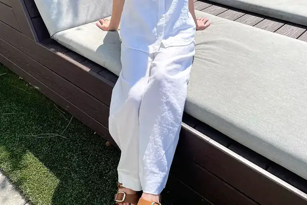 Person sitting on a cushioned bench wearing Tommy Bahama Two Palms High-Rise Linen Easy Pants