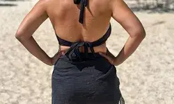 Back view of a woman wearing a Monday Swimwear South Beach Sarong on the beach