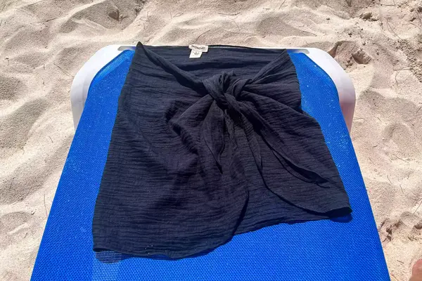 A Monday Swimwear South Beach Sarong on a lounge chair on the beach