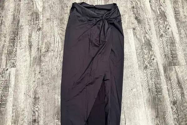 A Skims Swim Sarong Skirt lying on a floor