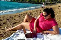 Woman lies on the beach wearing a CupShe Crochet Mini Dress