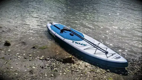 The Atoll 11-foot Inflatable Stand-up Paddle Board halfway in the water