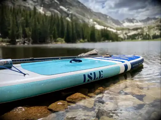 The Isle Pioneer 2.0 Inflatable Stand Up Paddle Board inflated on resting in a lake