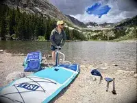 Peron pumping up Isle Pioneer 2.0 Inflatable Stand Up Paddle Board by lake