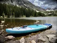 The Isle Pioneer 2.0 Inflatable Stand Up Paddle Board inflated in a lake