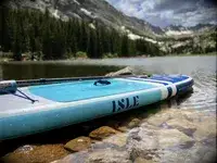 The Isle Pioneer 2.0 Inflatable Stand Up Paddle Board inflated on resting in a lake