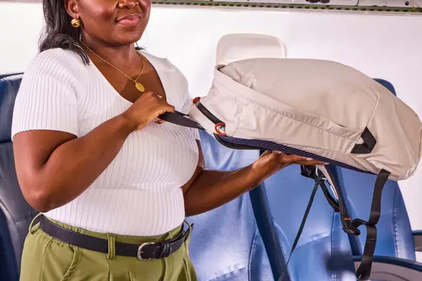A person holds up the Bellroy Lite Daypack