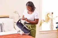 A person adjusts the straps on the Bellroy Lite Daypack