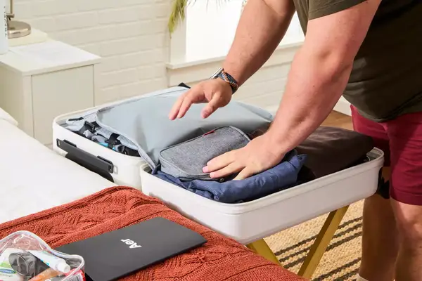 A person packing the Aer Carry-On Max