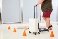 A person walking through cones with the Aer Carry-On Max