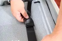 Two hands holding the straps of the Aer Carry-On Max