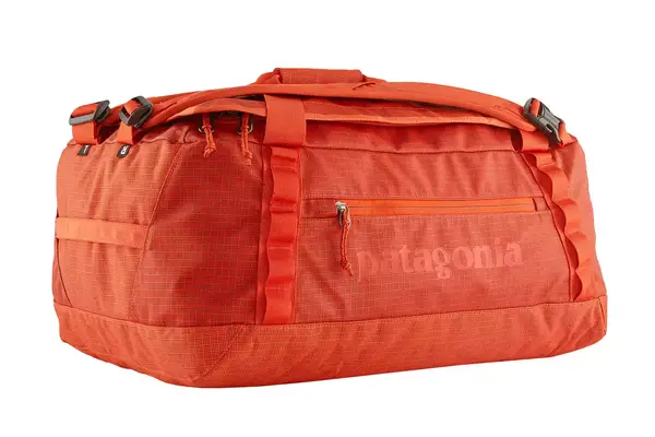 A person places a laptop into the front pocket of the Dagne Dover Smaller Seattle Carry-on Luggage 20.5 Inches